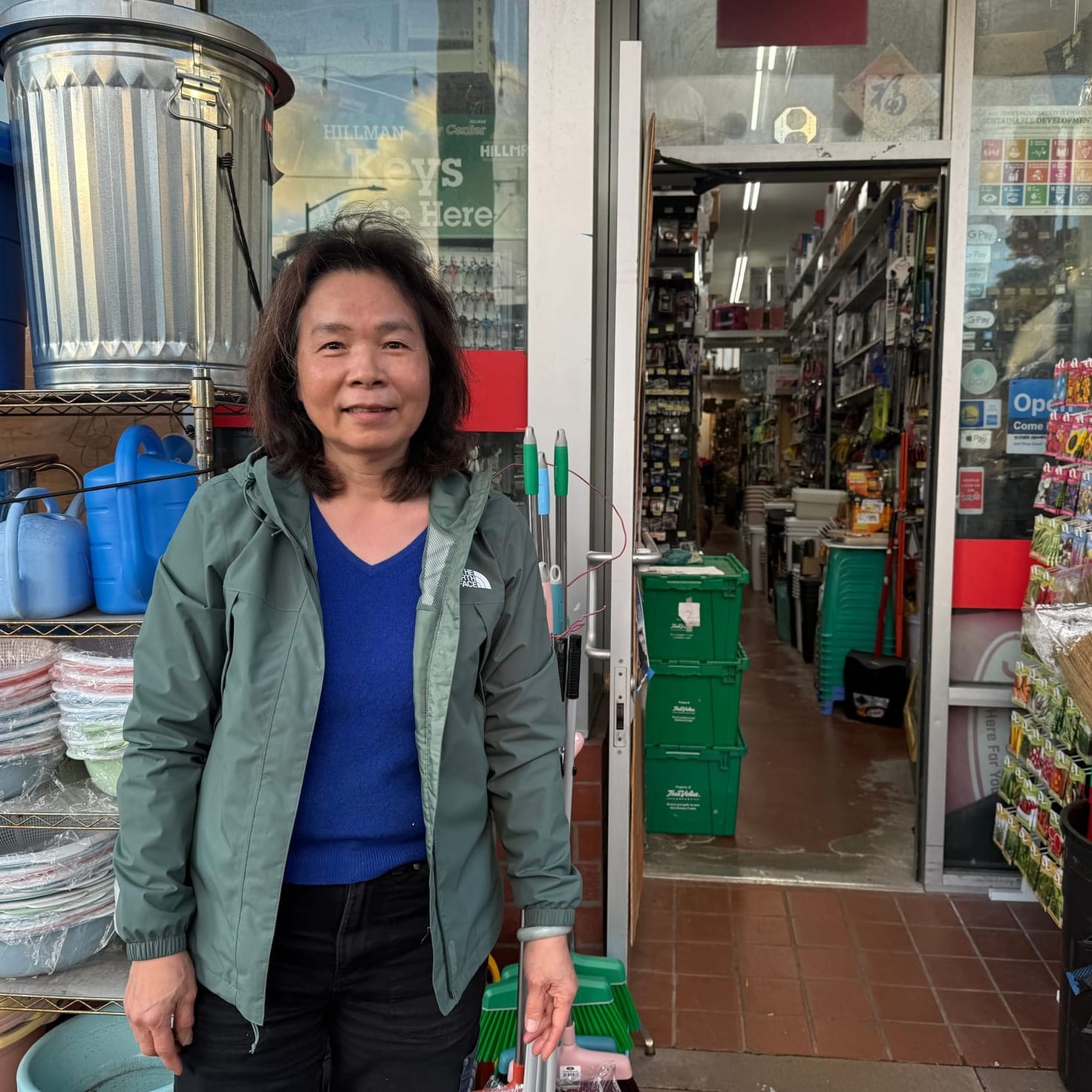 Woman standing in front of a shop.