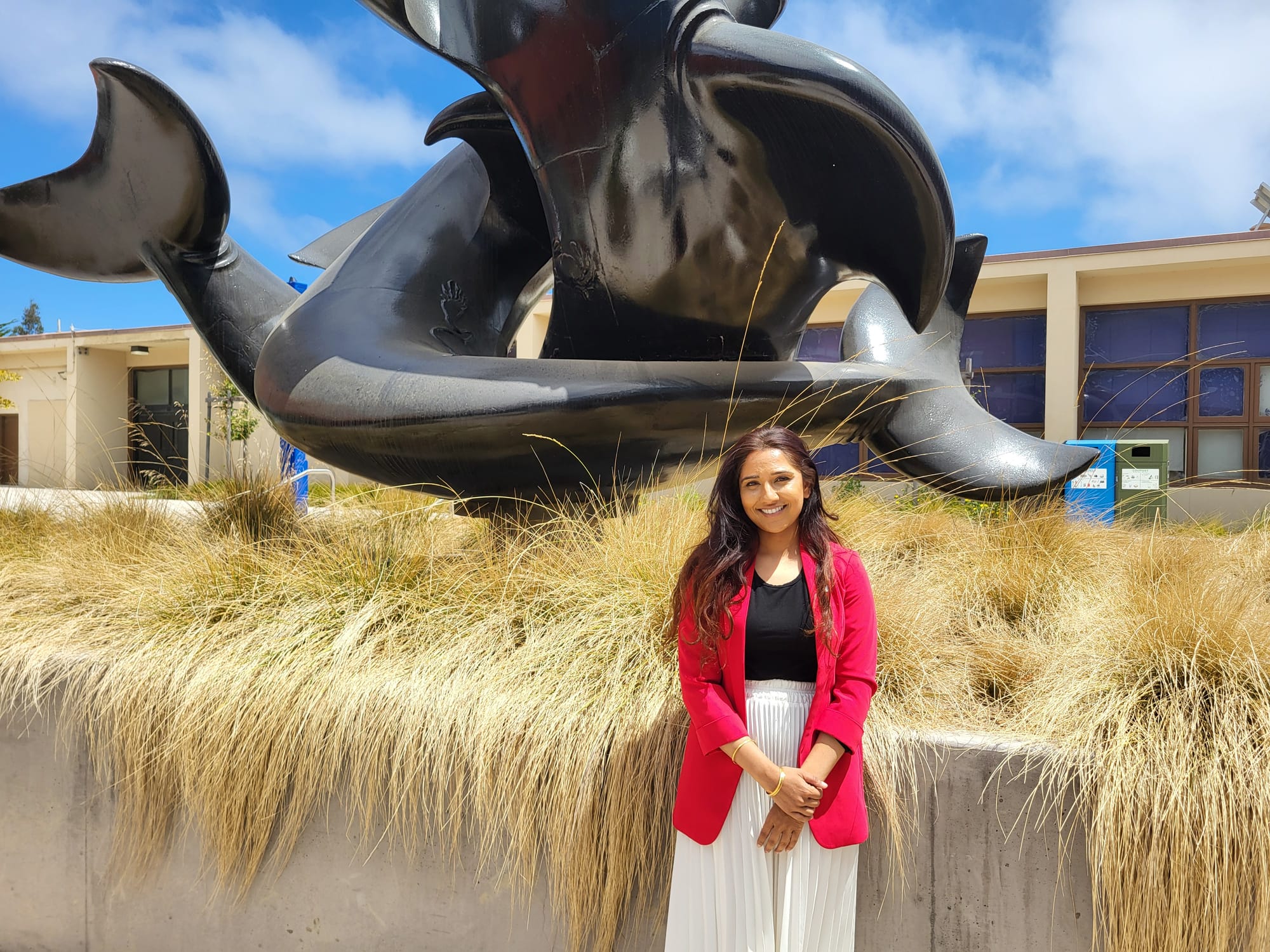Woman in front of a statue.