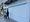 People walk past a storefront.