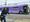 A man walks past a bus.