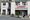 Two men stand in front of a supermarket.