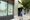 A woman walks past a storefront.