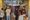 Eight people inside a coffee shop drinking and talking.