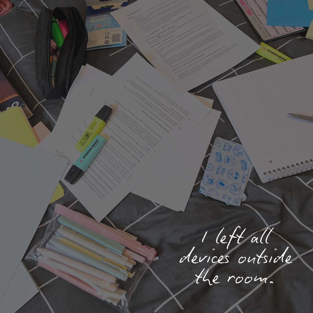 A photo of a bed covered in pens, paper, highlighters, and Blu-tac. Text reads: I left all devices outside the room.