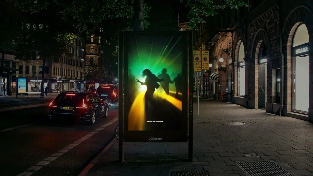 McDonalds Sweden advertisement showing rays of light resembling a golden arch in a nightclub.