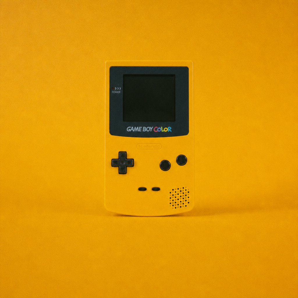 Yellow Nintendo Game Boy Color on yellow surface