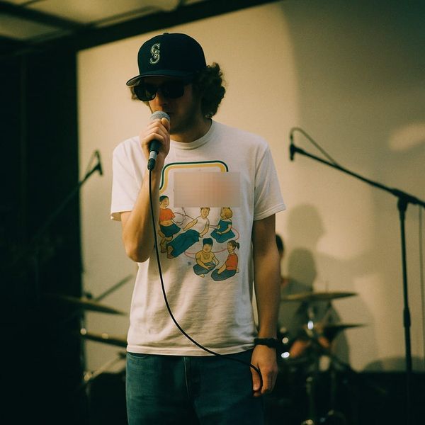 a man standing in front of a microphone on a stage