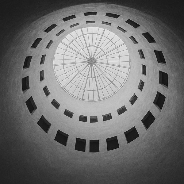 Looking up through a circular building atrium with skylight