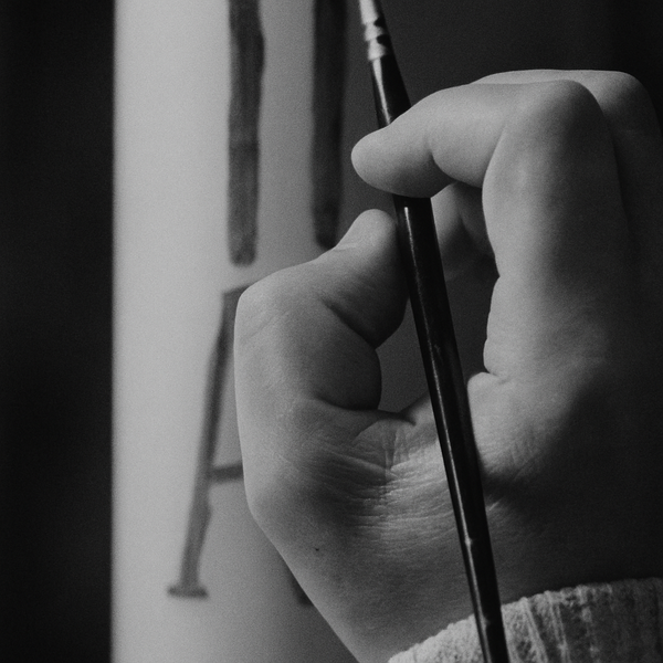 person holding black brush in close up photography