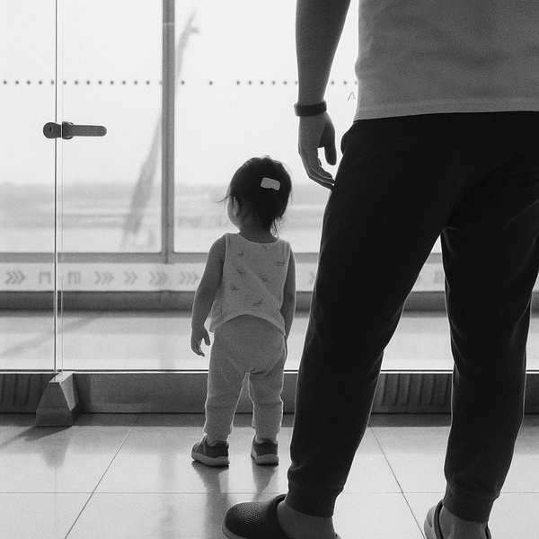 Father and daughter look out window