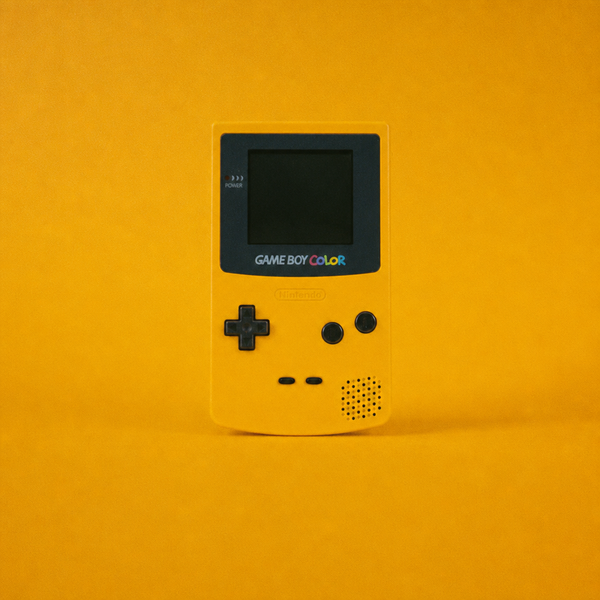 Yellow Nintendo Game Boy Color on yellow surface