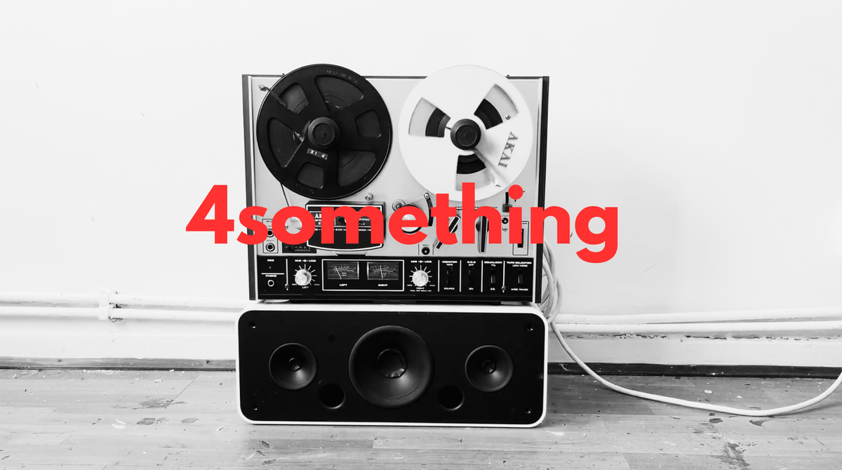 a black and white photo of a reel to reel tape recorder with the words 4something superimposed