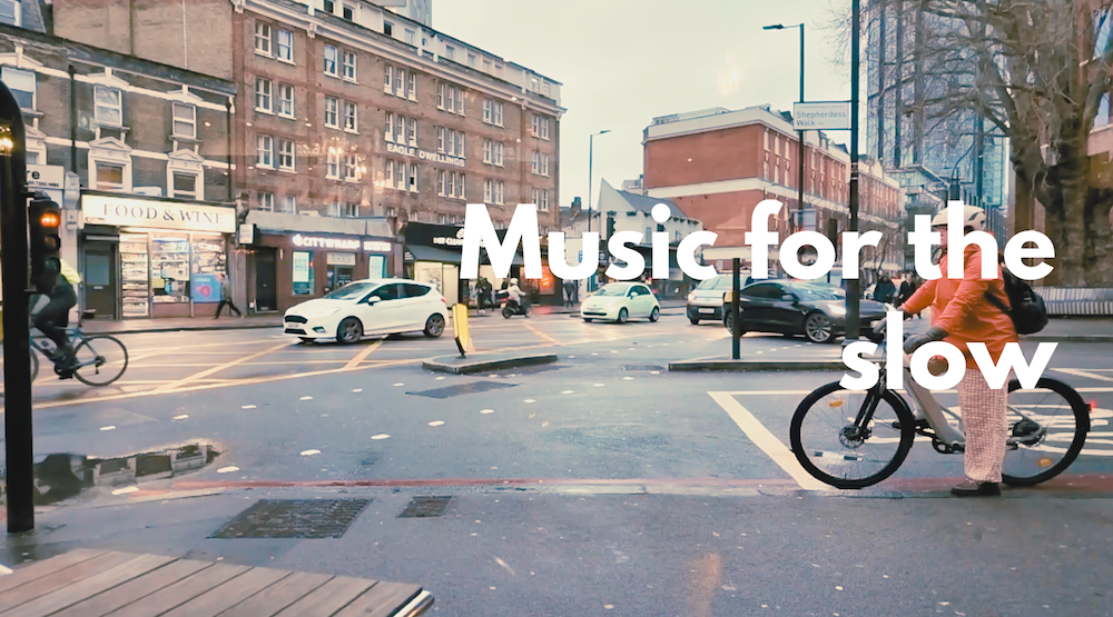 A street view with cars and bicycle with the text 'Music for the slow' superimposed