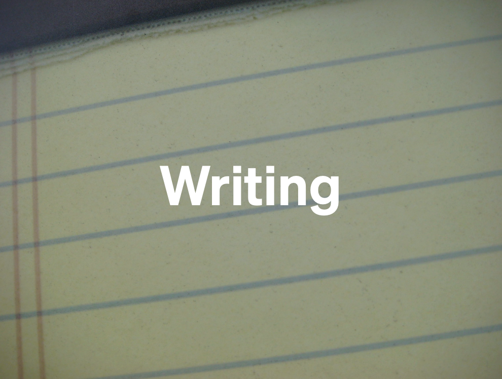 The word 'writing' superimposed on a blurry shot of a yellow legal pad