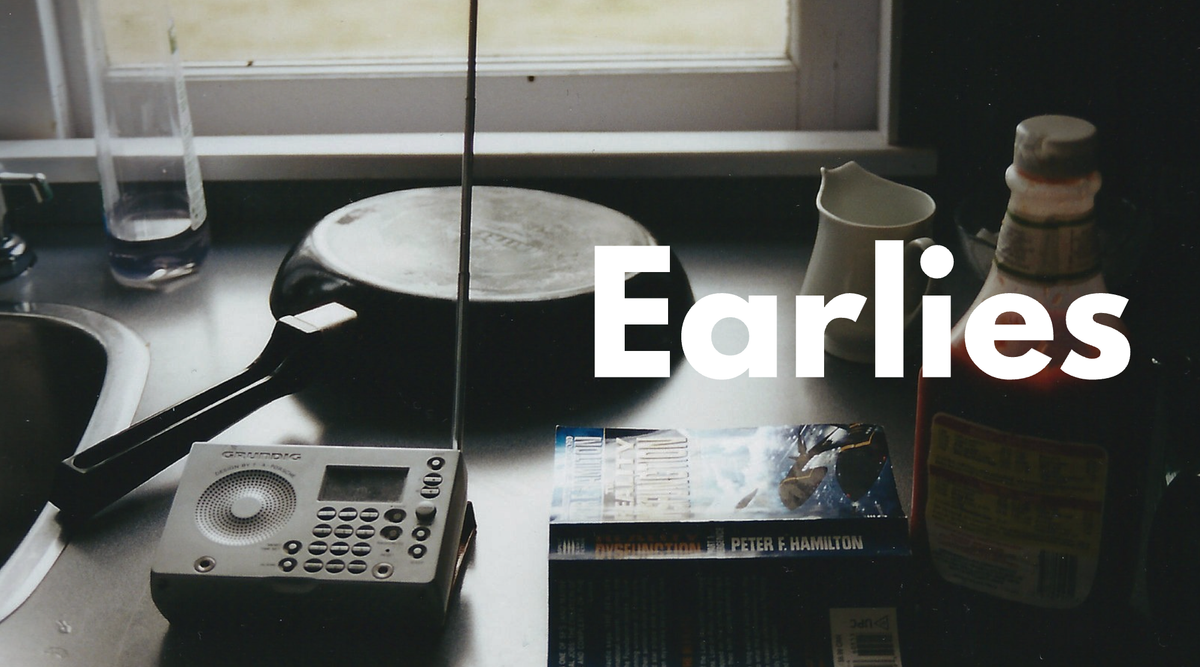 A kitchen counter with a frying pan and a radio and the word 'Earlies' superimposed
