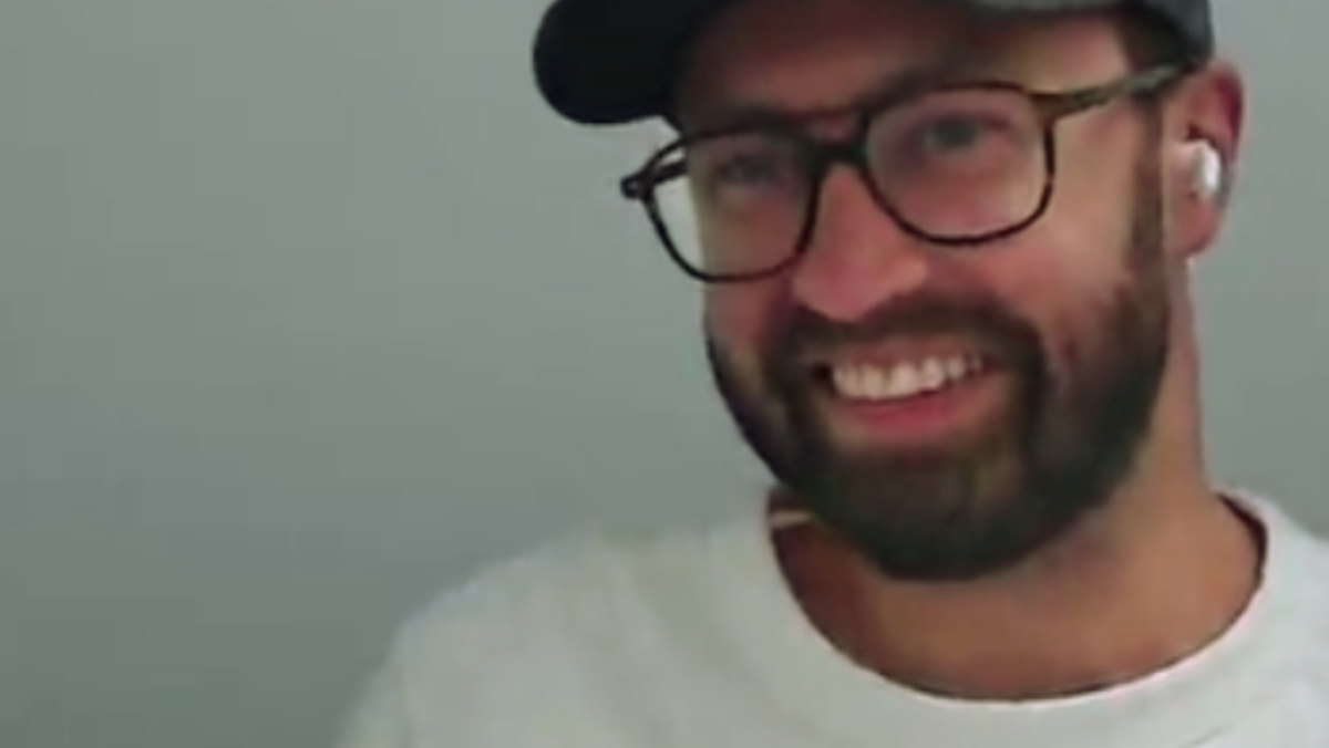Alex Morris in baseball cap, white tshirt and glasses