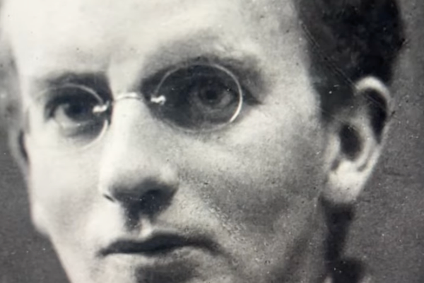 A close up of a man in glasses and black and white