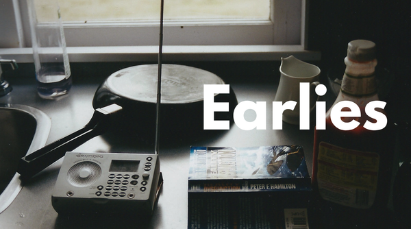 A kitchen counter with a frying pan and a radio and the word 'Earlies' superimposed
