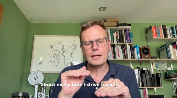Tom Whitwell, in a blue shirt and glasses in a screen grab from a video