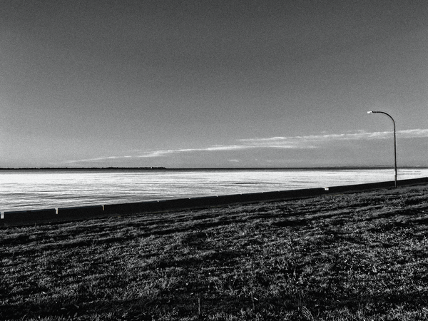 Footpath following along the bay with a single street light overlooking the path.