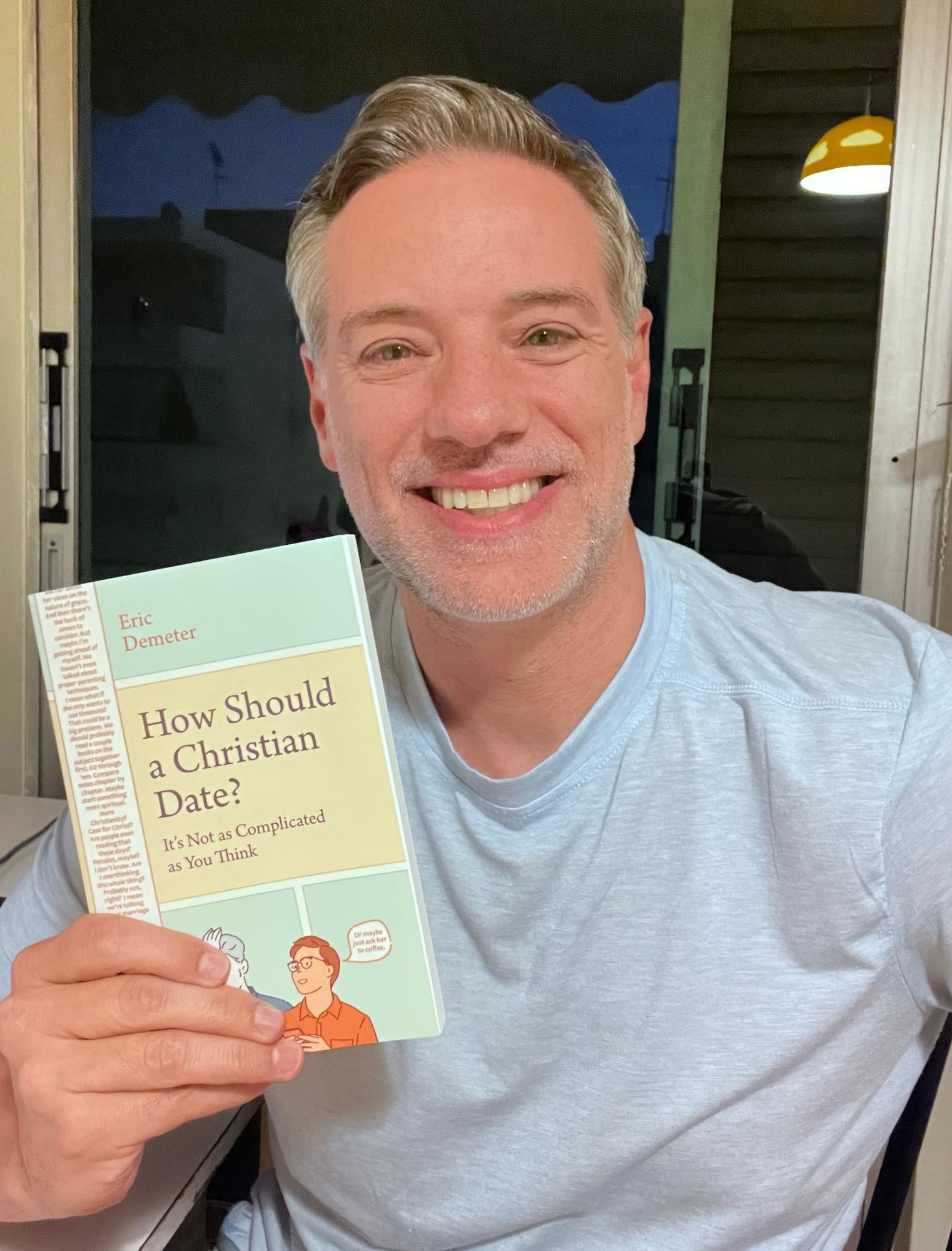 Eric Demeter holding his dating boo, How Should a Christian Date?