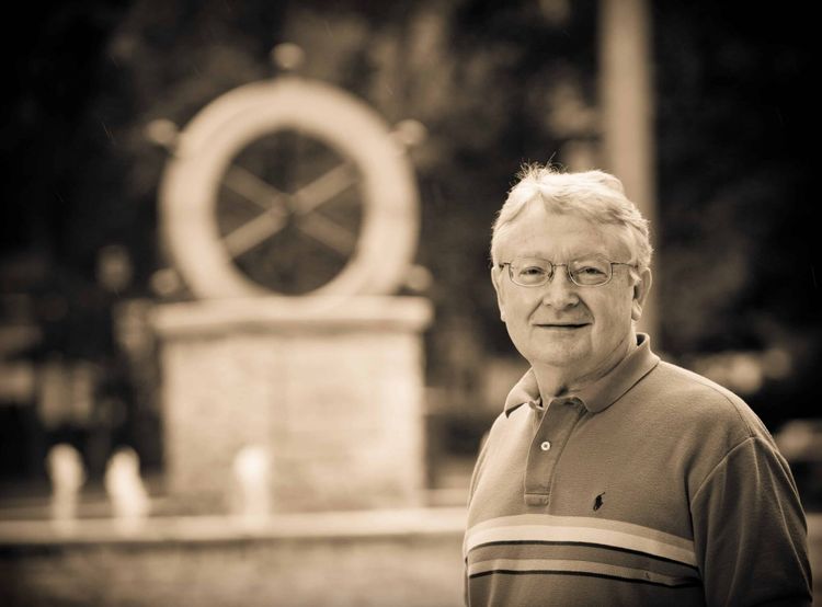 The late Dr. Gene Carpenter next to the helm at Bethel College, Mishawaka, Indiana