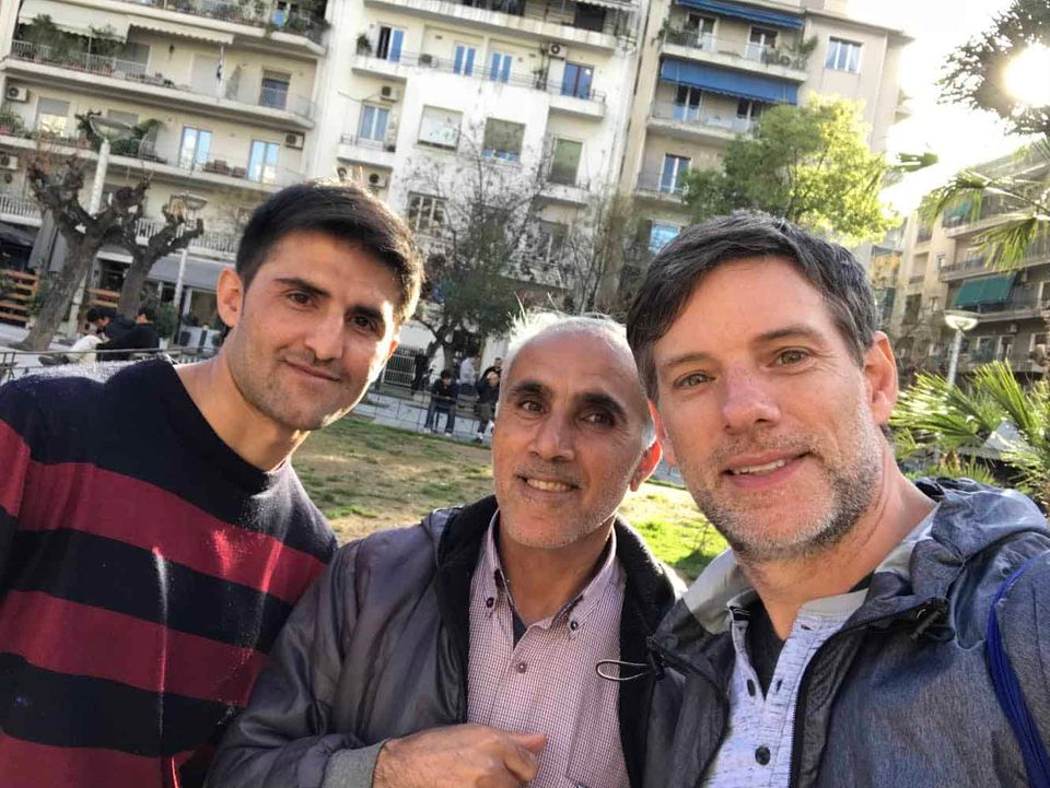 Me with two refugee friends from the Middle East standing in Victoria Park, Athens