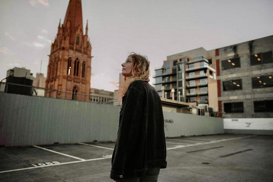 A woman looking looking at a church cathedral.