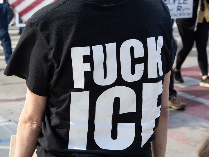 A photograph of a black t-shirt with white letters that says “Fuck ICE"