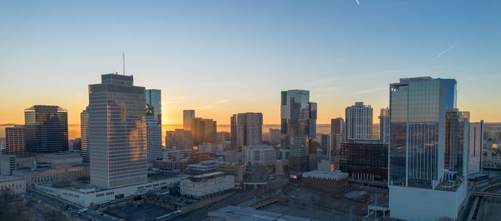 A low altitude aerial view of sky scrapers at sunrise. 