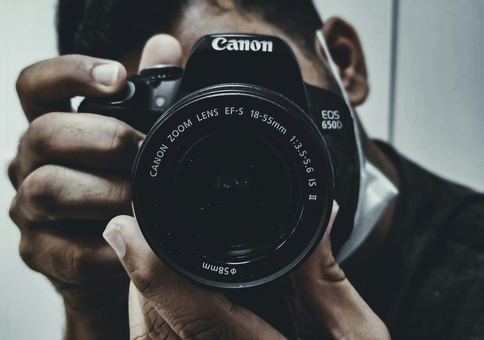 man holding black nikon dslr camera