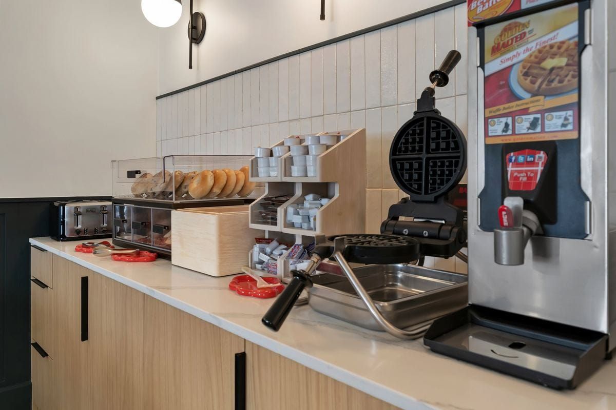 BOB's breakfast bar with a waffle iron, batter dispenser and fresh bagels
