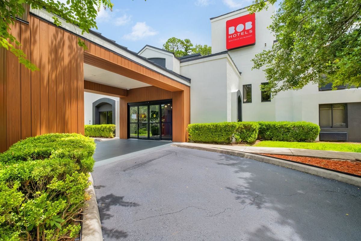 The BOB Hotels entrance with its wood-clad porch and red logo