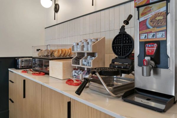 BOB's breakfast bar with a waffle iron, batter dispenser and fresh bagels