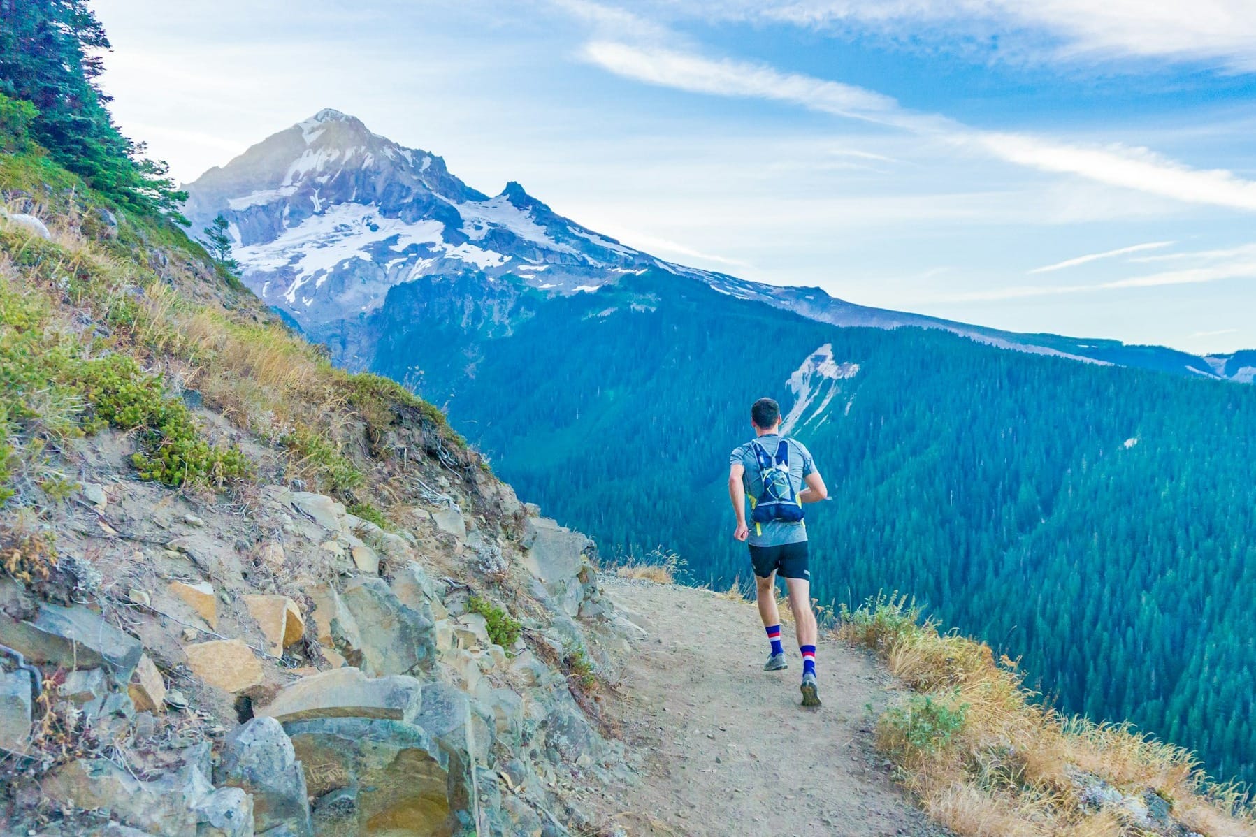 man running on edge near mountain