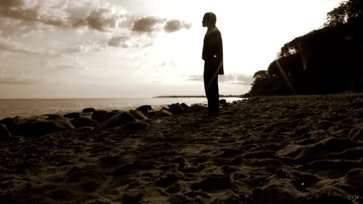 Man standing at edge of sea on beach