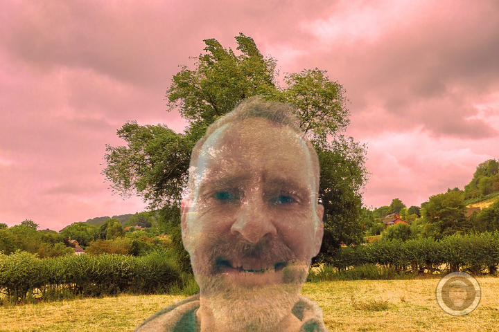 CJB face large front and center and huge tree behind in distance and stormy skies