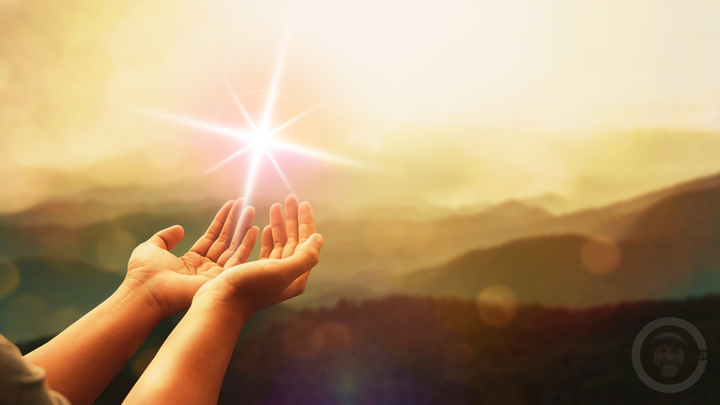 open hands with sparkle rising into air 