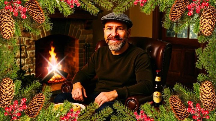 CJB SITTING IN FRONT OF A CHRISTMAS COZY FIREPLACE SMILING
