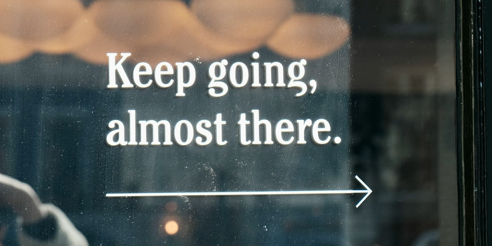 a window with a sign that says keep going, almost there