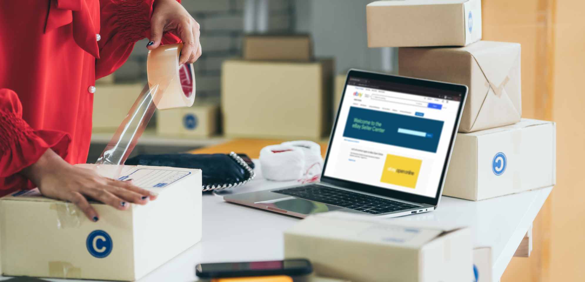 E-commerce seller packs boxes for shipment