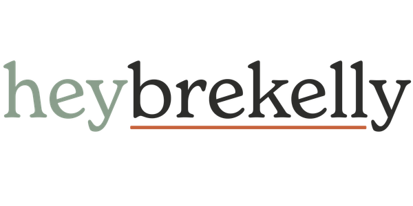 heybrekelly word mark. "hey" in sage green, "brekelly" in deep charcoal and underlined with a dusty ember line.