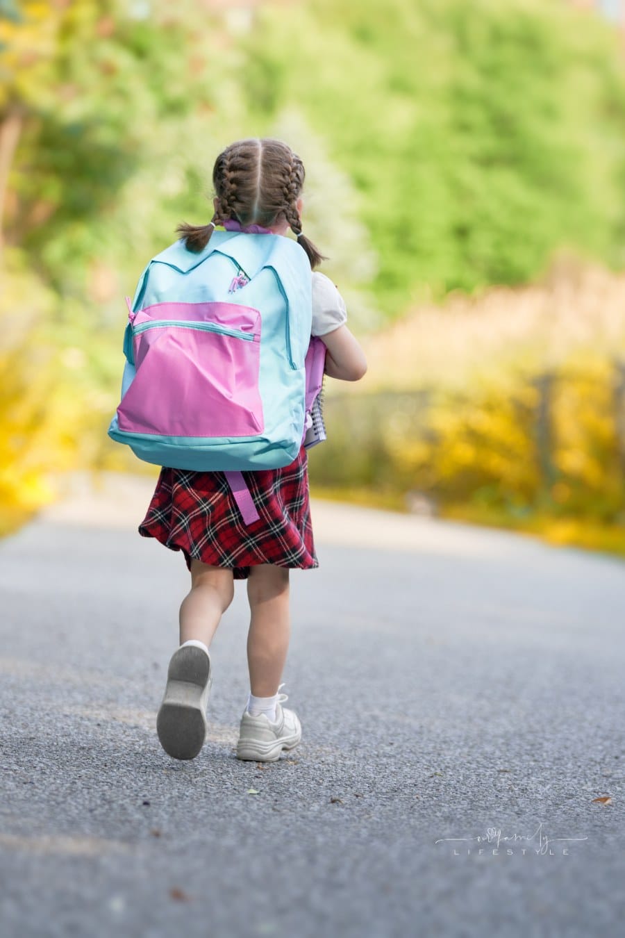 Girl with backpack on walking to school