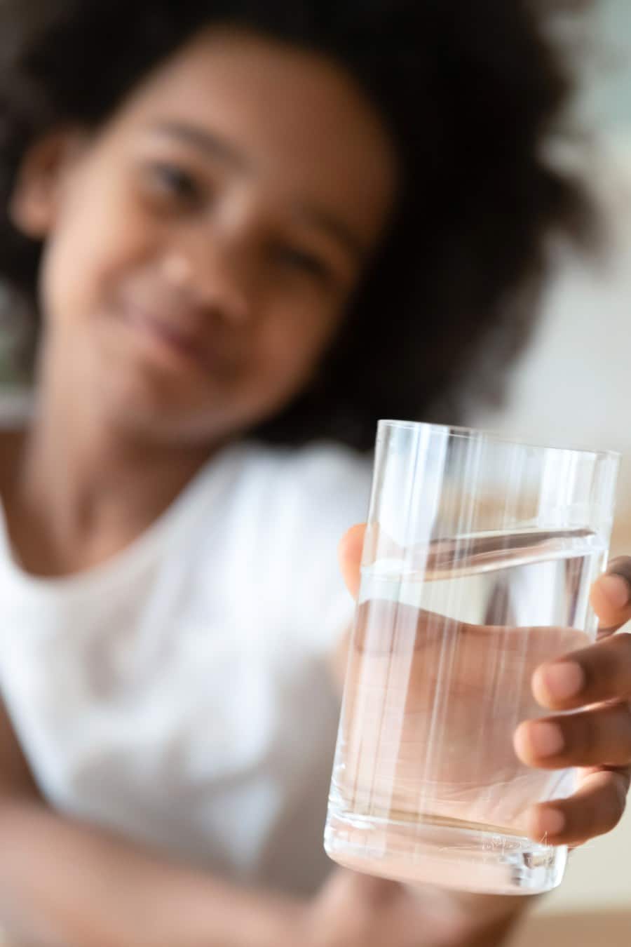 Portrait of happy child enjoying drinking water.