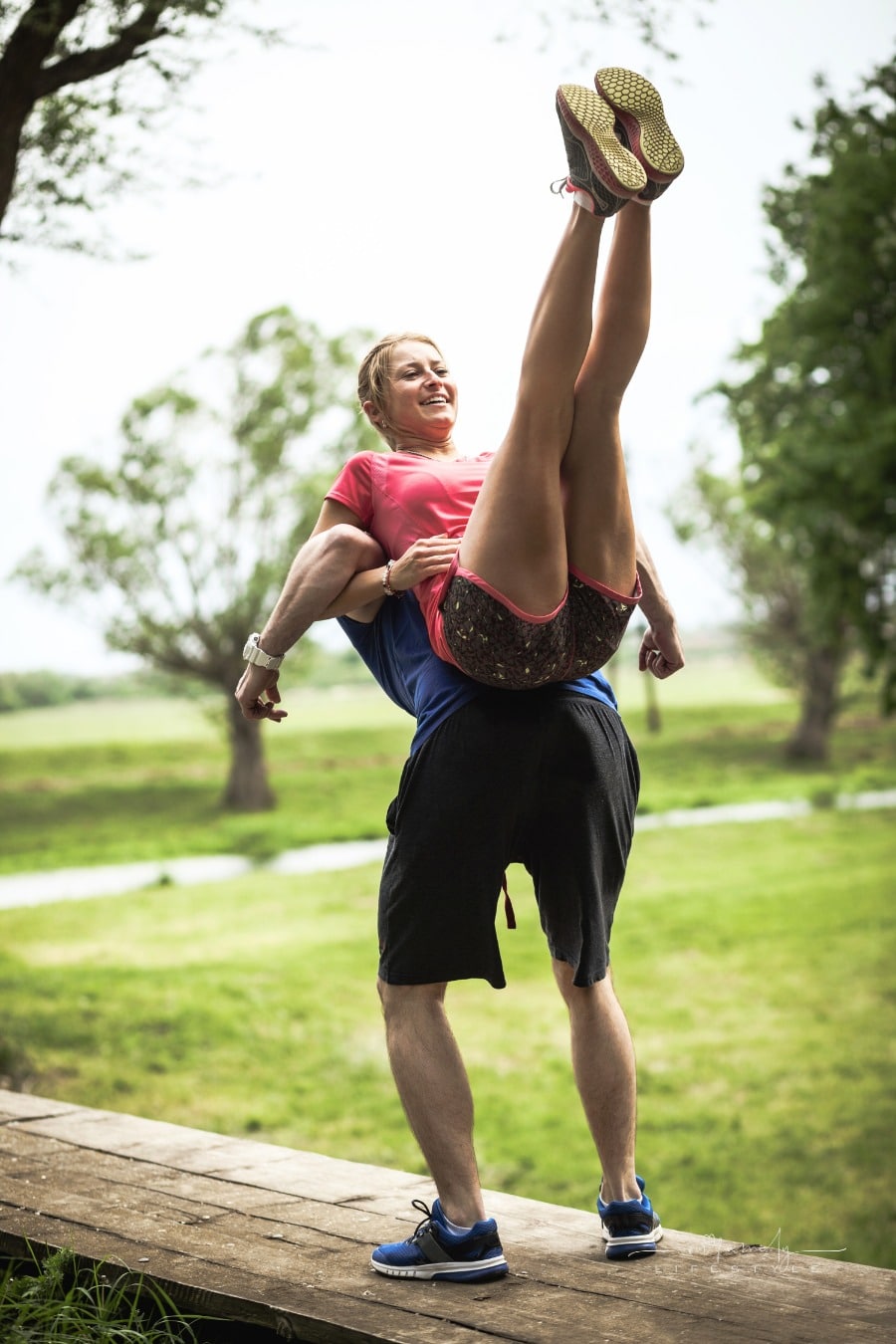 happy couple doing stretching exercises before running together