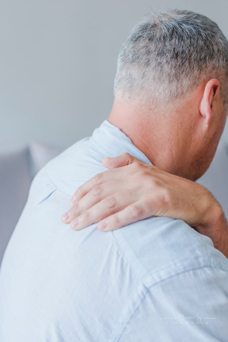 man holding shoulder due to joint pain