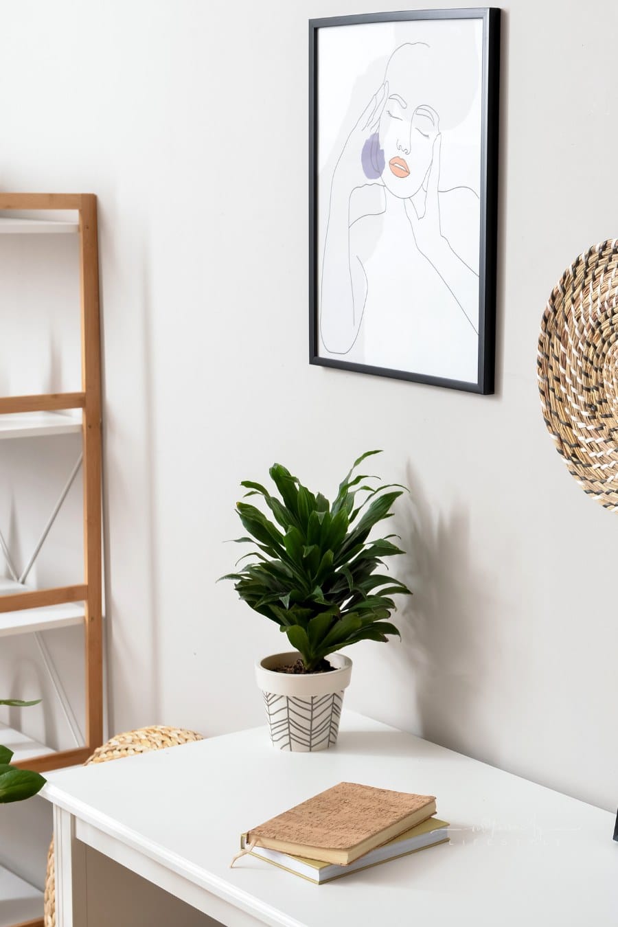 Modern Workplace and Pictures Hanging on Light Wall