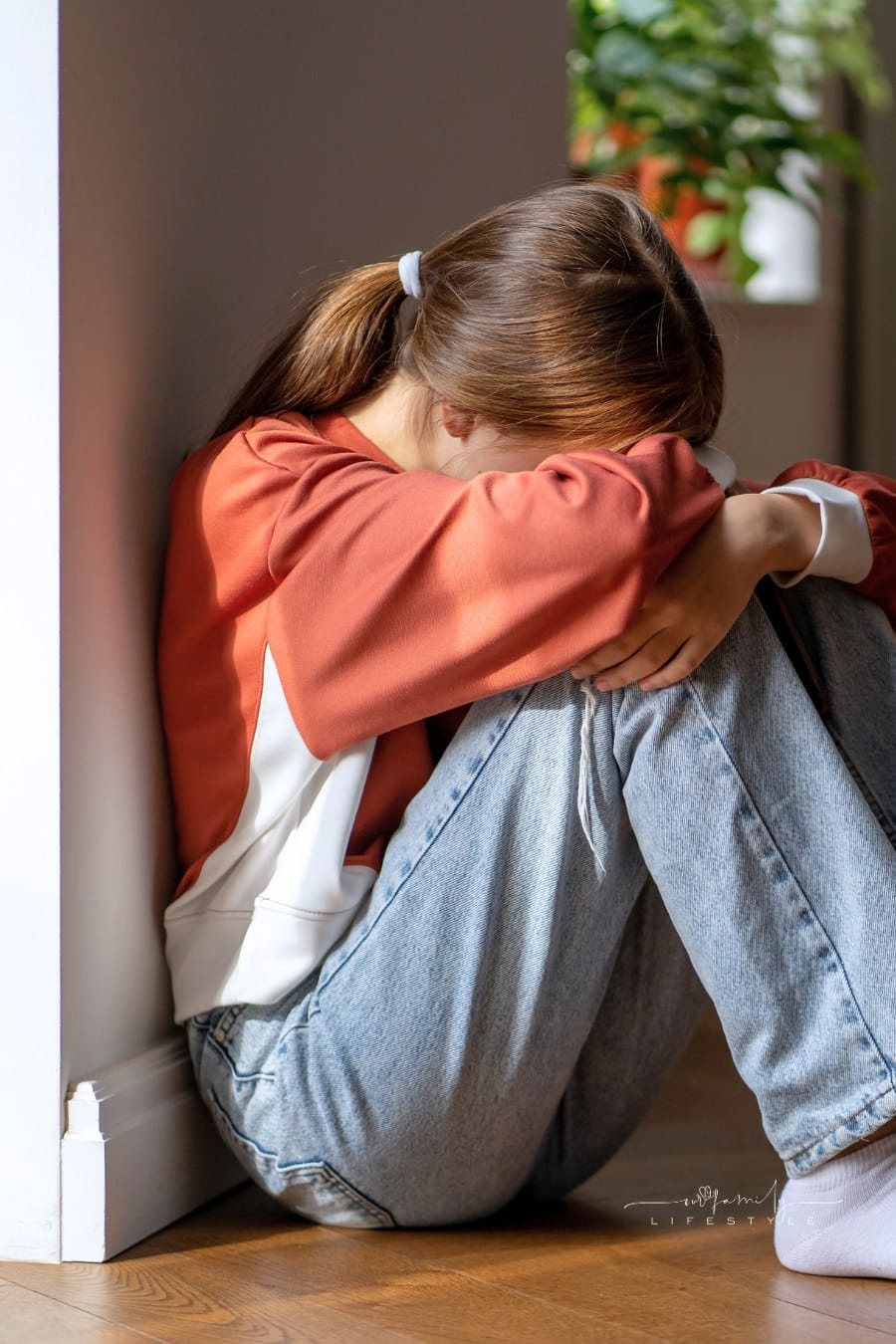 Upset Depressed Teenage Girl Sitting Alone on Floor and Crying