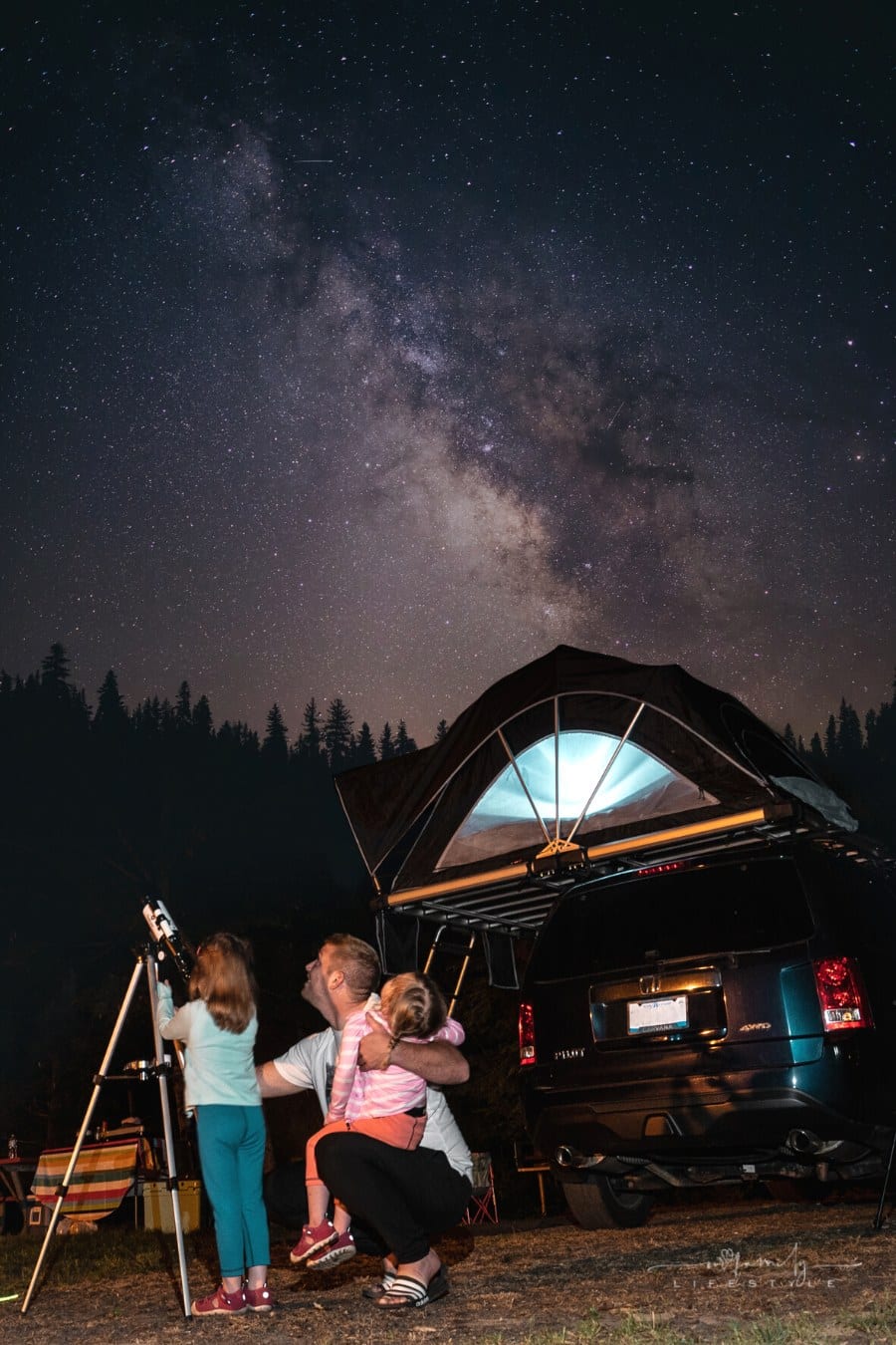 father stargazing during camping trip with kids