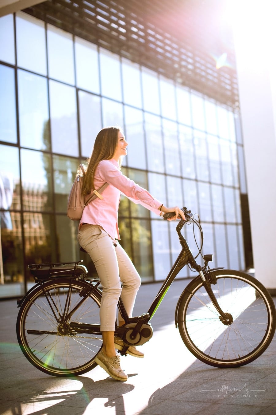 young woman riding an e-bike on a sunny day